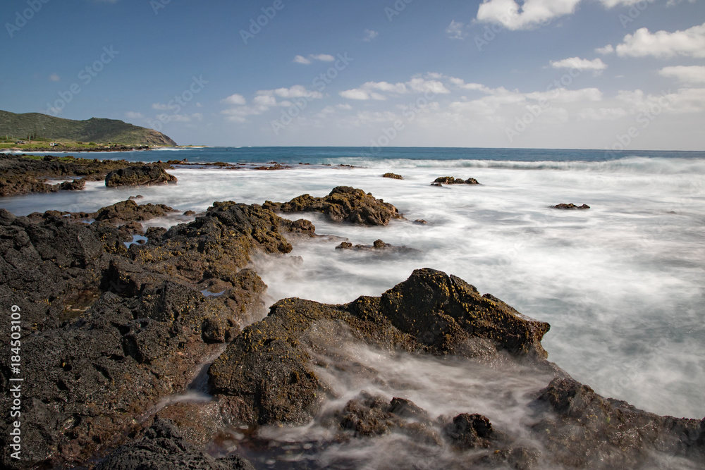 Ocean waves flowing into rocks and back to the sea creating beautiful water pattern, Sandy beach, Oahu, Hawaii Ocean waves flowing into rocks and back to the sea creating beautiful water pattern, Sandy beach, Oahu, Hawaii