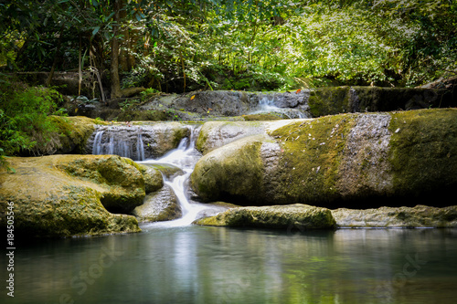 Fototapeta Naklejka Na Ścianę i Meble -  Waterfall hidden in the tropical jungle (erawan waterfall) in kanchanaburi province asia southeast asia Thailand
