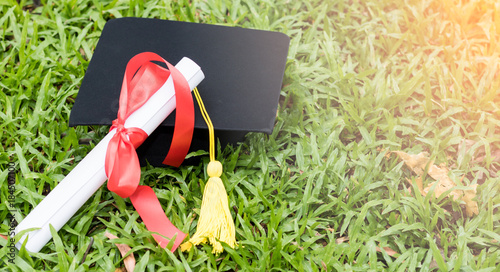 graduate hat and certificated on green gass in garden photo