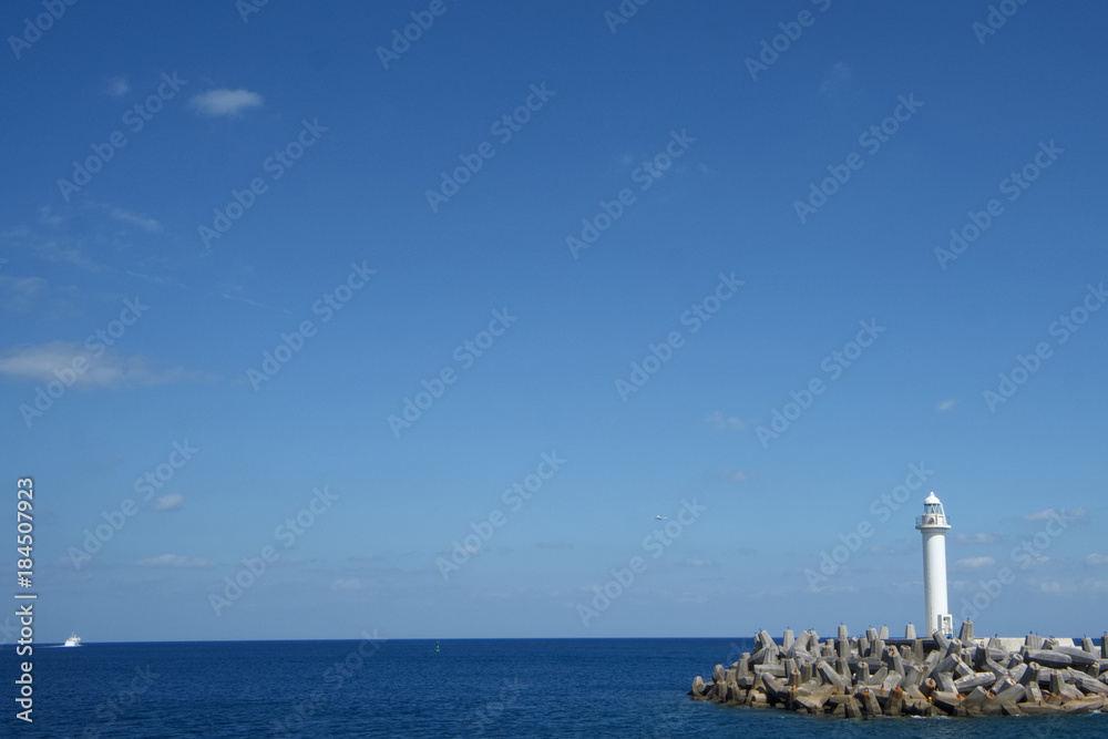Lighthouse and the sea in Japan. Lighthouse is building that containing a beacon light to warn or guide ships at sea.