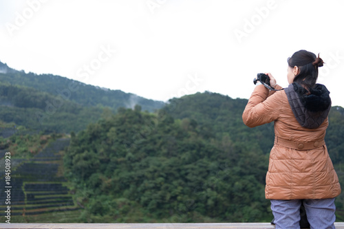 tourist use camera to take picture of mountain view. people, travel, nature concept.