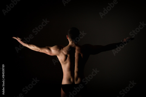Strong muscular man torso poses on black background