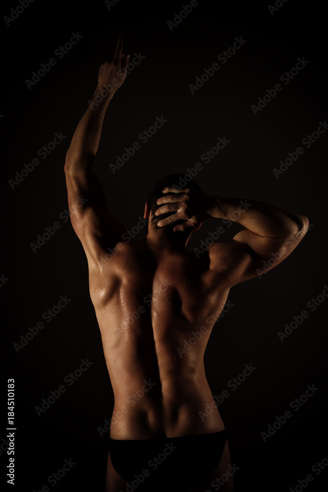Strong muscular man torso poses on black background