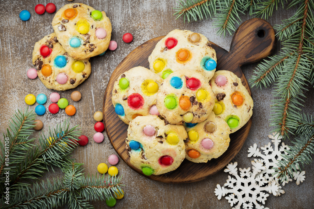 Children's cookies with colorful chocolate sweets in sugar glaze on brown concrete or stone background. Christmas card. Selective focus. Top view. Place for text. Children's cookies with colorful chocolate sweets in sugar glaze on brown concrete or stone background. Christmas card. Selective focus. Top view. Place for text.
