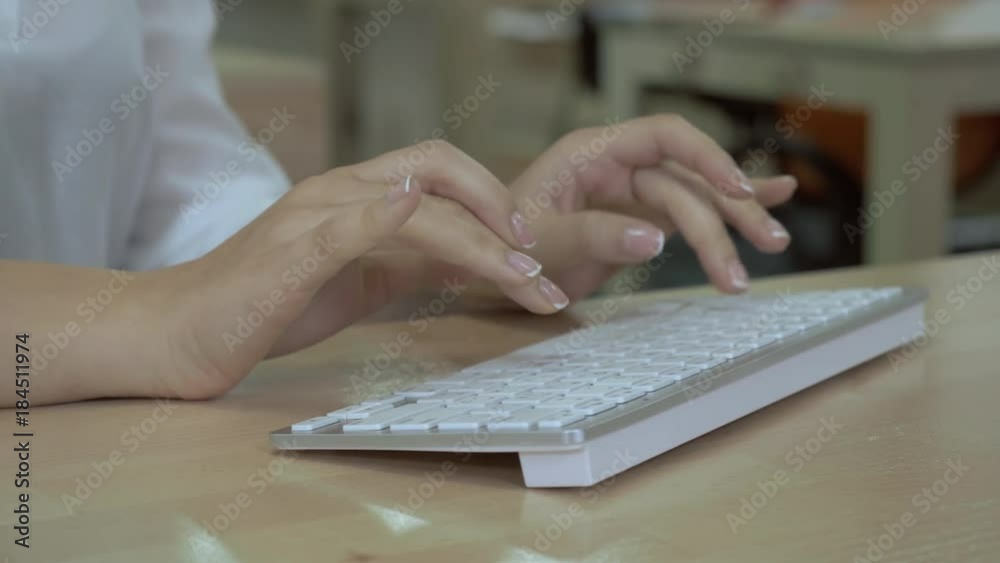 close up details woman’s hands typing fast on white keyboard. unrecognizable businesswoman entering data on pc sitting at the wooden desk in office close up details woman’s hands typing fast on white keyboard. unrecognizable businesswoman entering data on pc sitting at the wooden desk in office