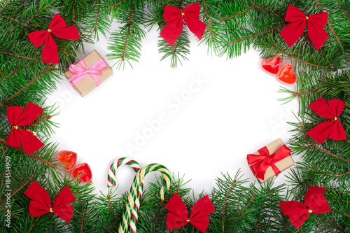Christmas frame decorated with red bows isolated on white background with copy space for your text. Top view