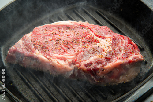 rib eye steak on grill pan