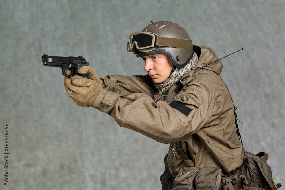 Fototapeta premium Soldier man holding his gun