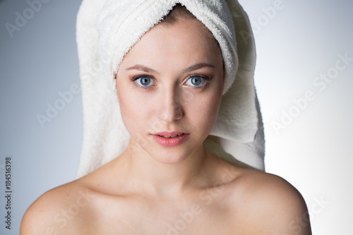 Face of a beautiful young woman with a towel