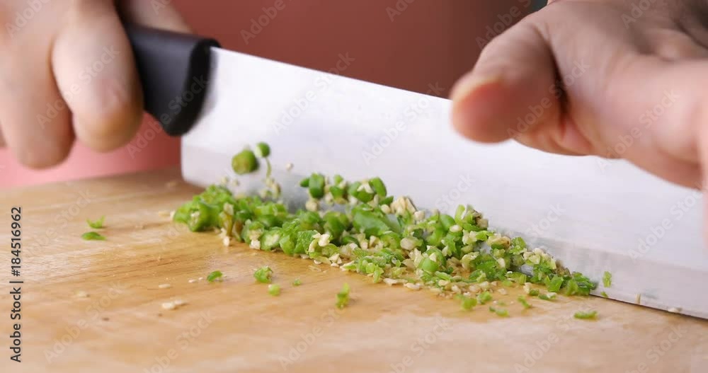 chef cooking food sliced chili with knife on wooden chopping board chef cooking food sliced chili with knife on wooden chopping board