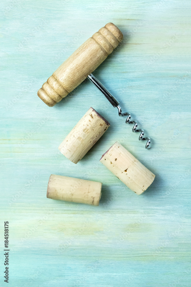 Vintage corks and corkscrew on teal with copy space