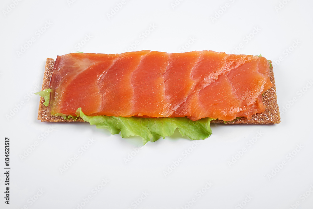 Low caloric open sandwich with red fish. Isolated on white background Low caloric open sandwich with red fish. Isolated on white background