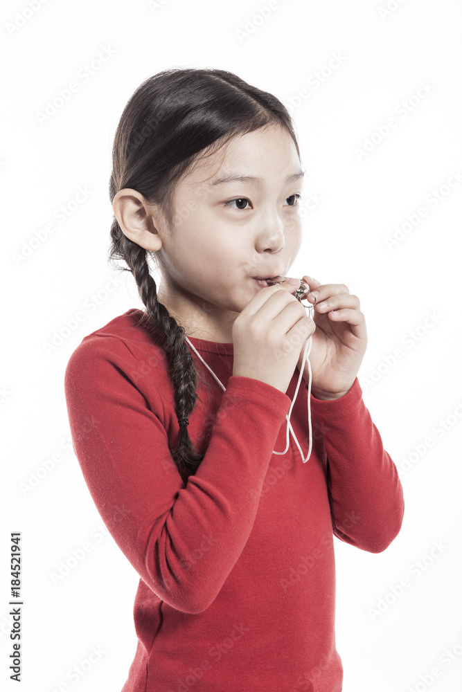 girl hand holding a whistle with smile isolated on the white background. girl hand holding a whistle with smile isolated on the white background.