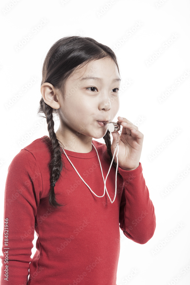 girl hand holding a whistle with smile isolated on the white background. girl hand holding a whistle with smile isolated on the white background.