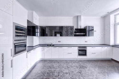 Modern design white kitchen in a spacious apartment.