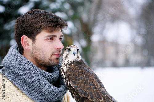 man with a feathered pet photo