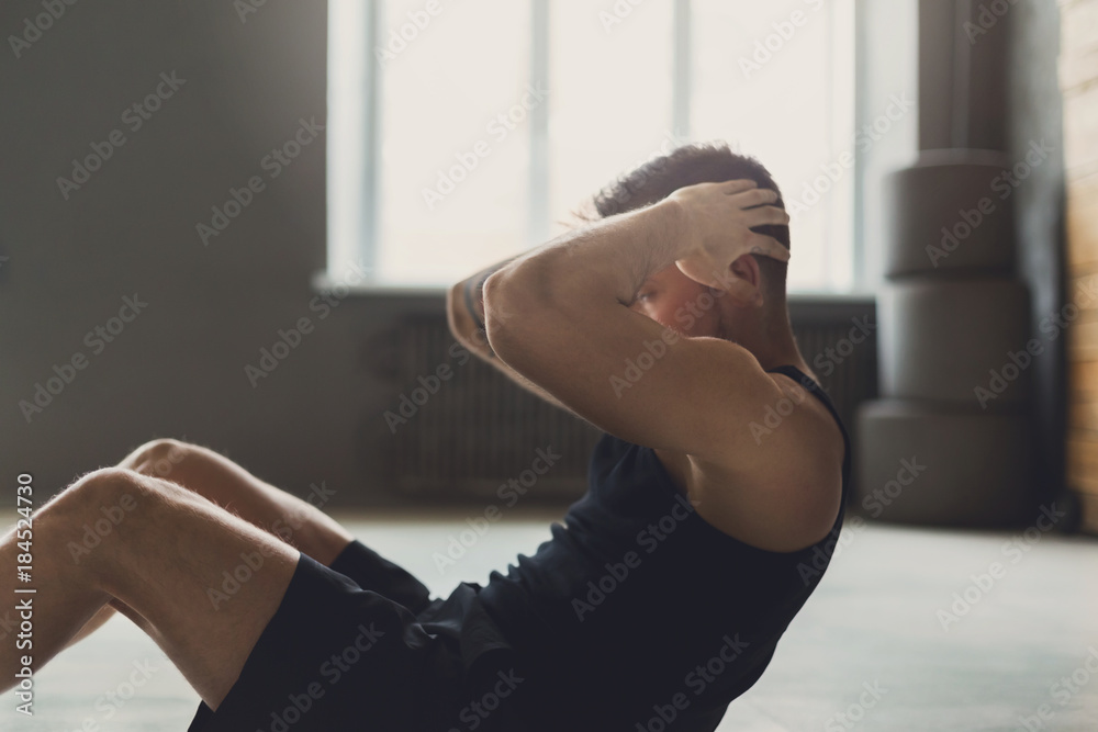 Fototapeta premium Young man fitness workout, sit-up crunches for abs
