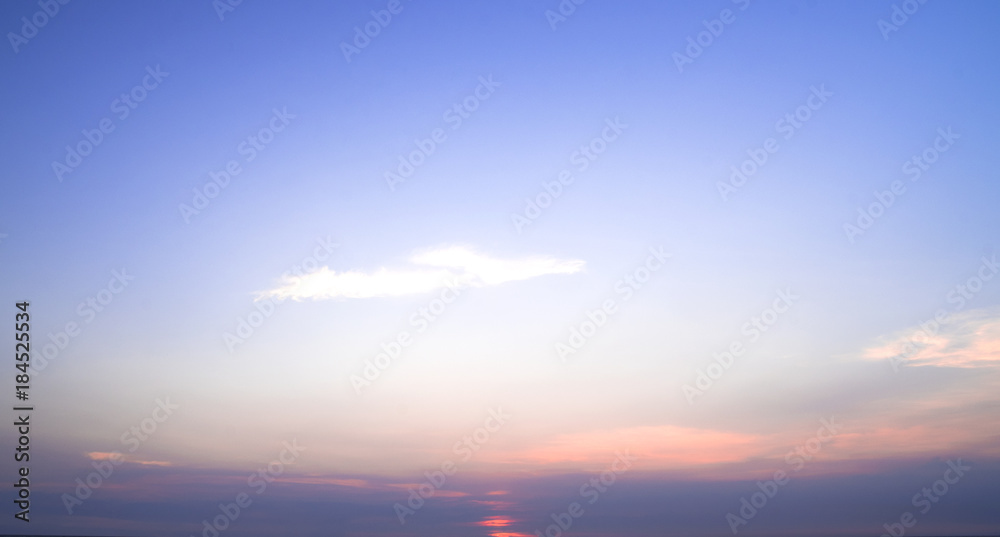 Sunset with soft blue sky background

