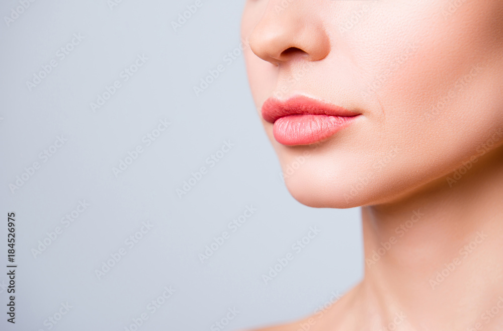 Cropped close up photo of beautiful woman's lips with shape correction, isolated on grey background, copyspace Cropped close up photo of beautiful woman's lips with shape correction, isolated on grey background, copyspace