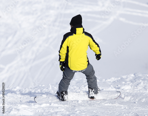 Man is snowboarding in the snow in winter