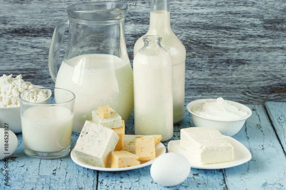 Set of different milk products on the wooden background Set of different milk products on the wooden background