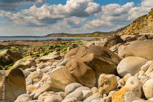 Stones and clouds at Osmington Bay, Osmington Mills, near Weymouth, Jurassic Coast, Dorset, UK photo