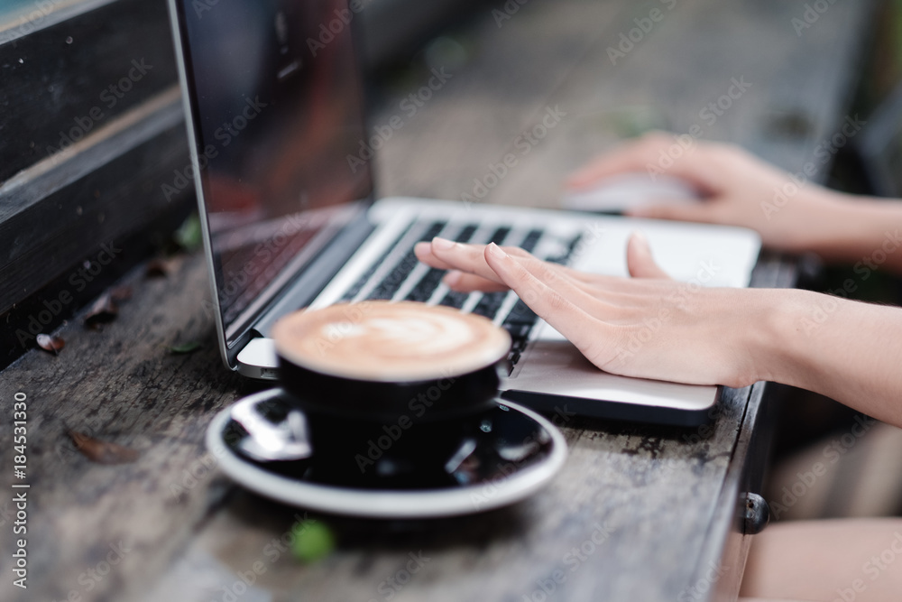 Woman hands typing on laptop keyboard at the office, Woman worker and business concept, Soft focus on vintage wooden table. Woman hands typing on laptop keyboard at the office, Woman worker and business concept, Soft focus on vintage wooden table.