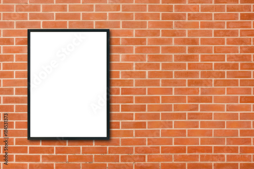 Mock up blank poster picture frame hanging on red brick wall background in room - can be used mock up for montage products display and design key visual layout. Mock up poster in interior background.