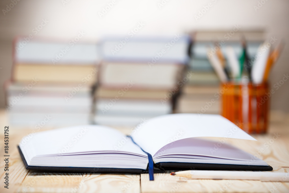 Fototapeta premium Textbooks and books on a wooden table