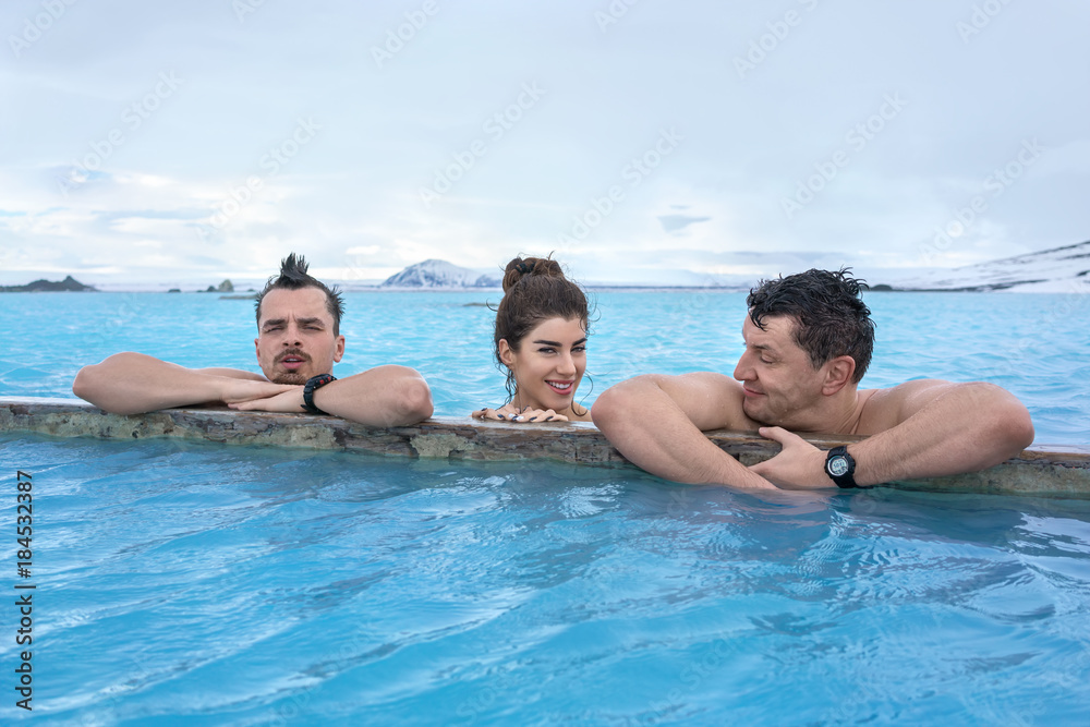 People relaxing in geothermal pool outdoors