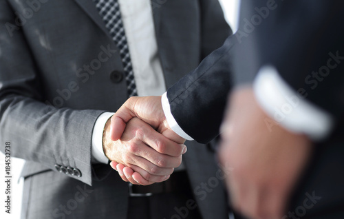 Friendly smiling businessmen handshaking. Business concept photo © ASDF