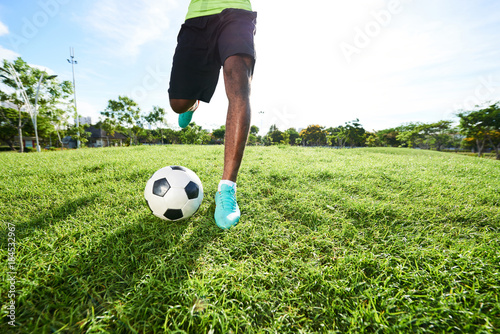 Kicking Soccerball on Field © DragonImages