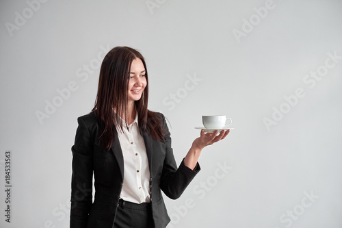 office worker offering you a cup of coffee or tea over white background photo