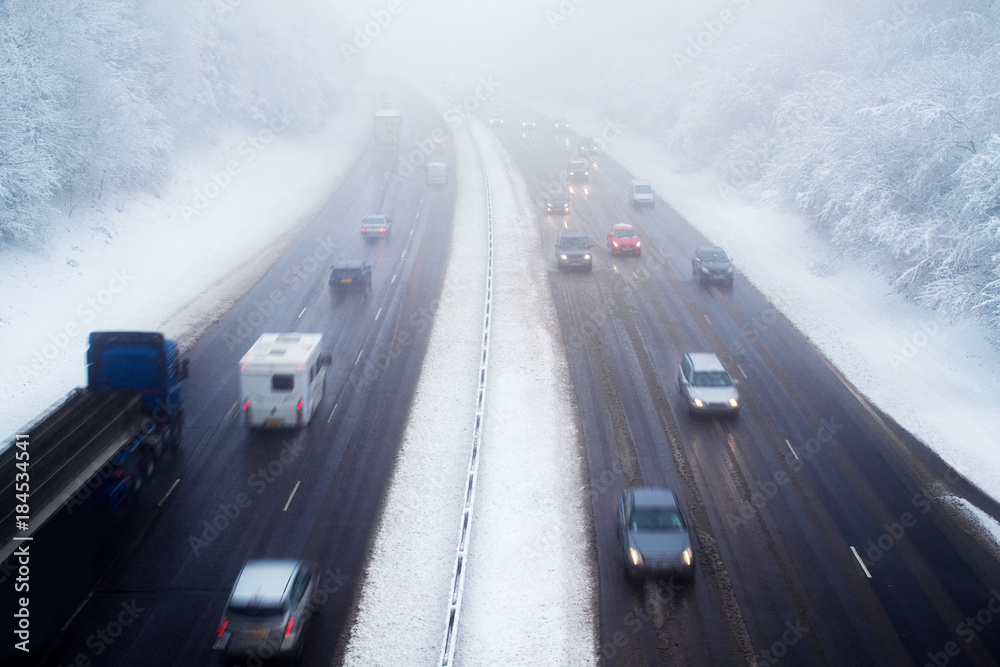 Obraz premium Traffic On Motorway During Snow Storm