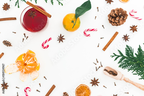 Fototapeta Naklejka Na Ścianę i Meble -  Christmas hot mulled wine with cinnamon, anise and candy cane on white background. Frame composition. Flat lay, top view