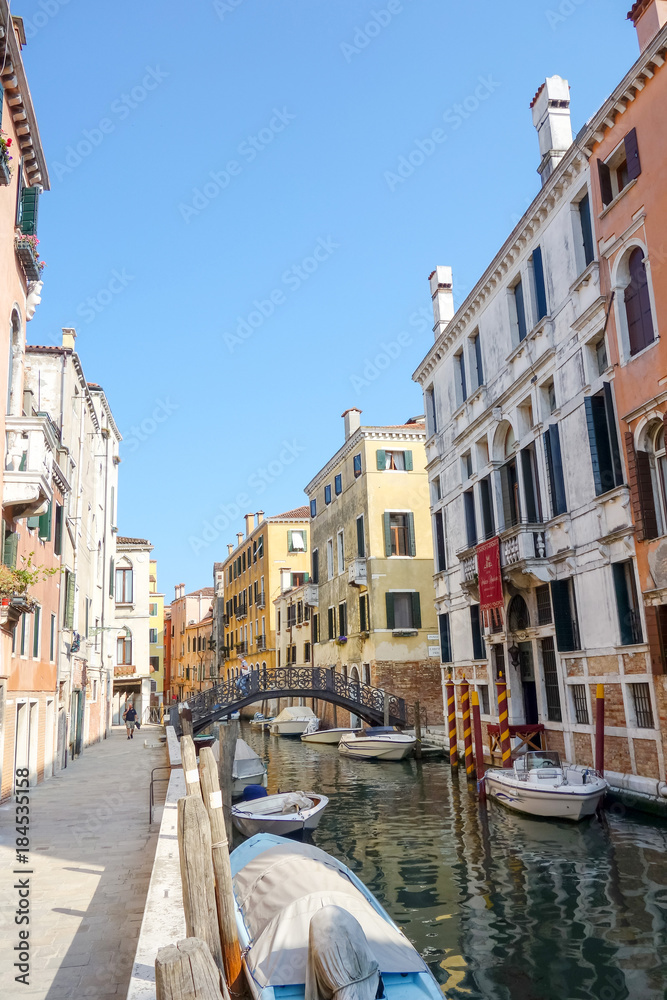 Naklejka premium VENICE, ITALY - May 18, 2017 : View of water street and old buildings in Venice on May 18, 2017. its entirety is listed as a World Heritage Site, along with its lagoon