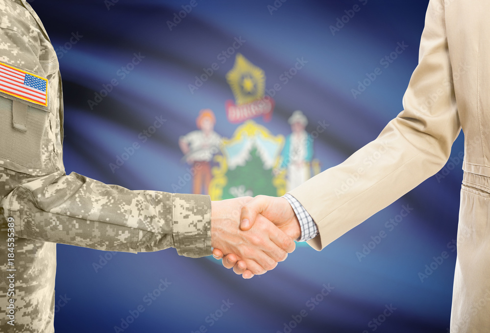 Φωτογραφία USA military man in uniform and civil man in suit shaking hands with certain USA
