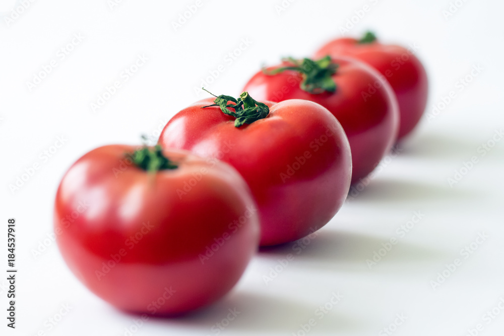 Bunch of fresh tomatoes with water drops. Isolated on white background. Top view. Bunch of fresh tomatoes with water drops. Isolated on white background. Top view.