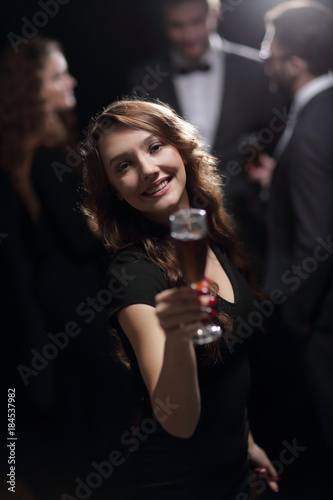 beautiful young woman raising his glass in a casino
