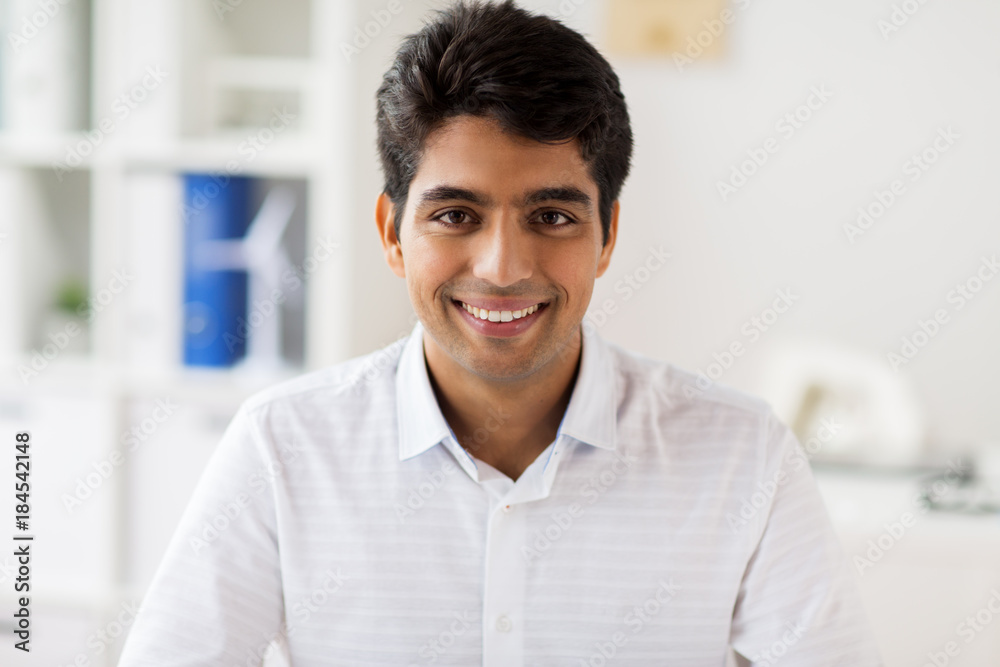 smiling indian businessman at office