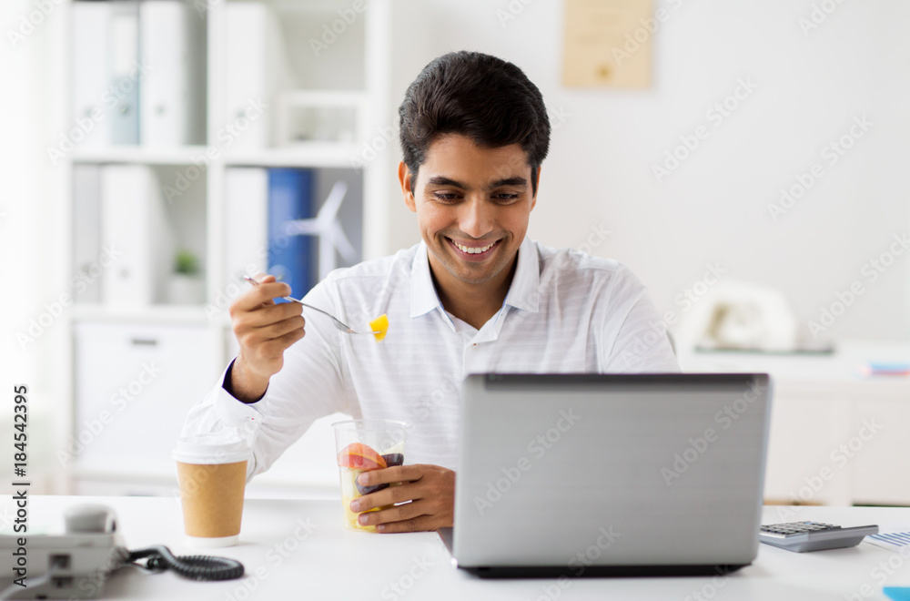 businessman with laptop eating fruits at office businessman with laptop eating fruits at office