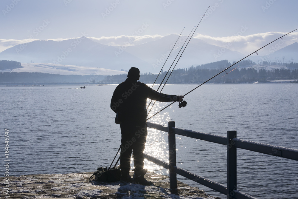fisherman silhouette at winter morning, Liptovska Mara dam, Slovakia