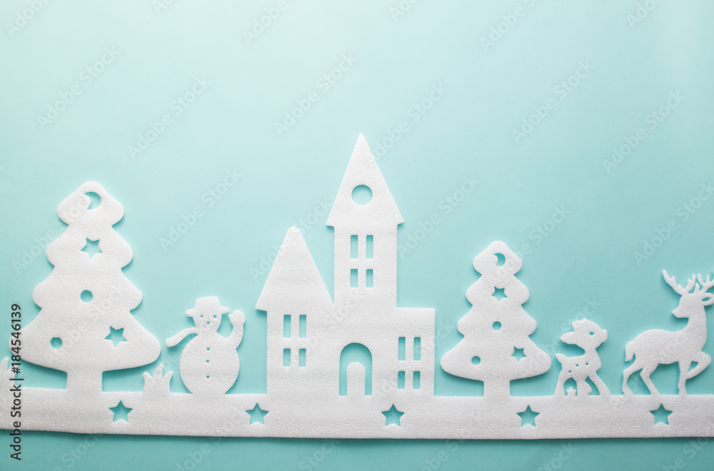 Merry Christmas and Happy New Year. Foam cutter of City with reindeers and snow boy, art and craft style on pastel color paper