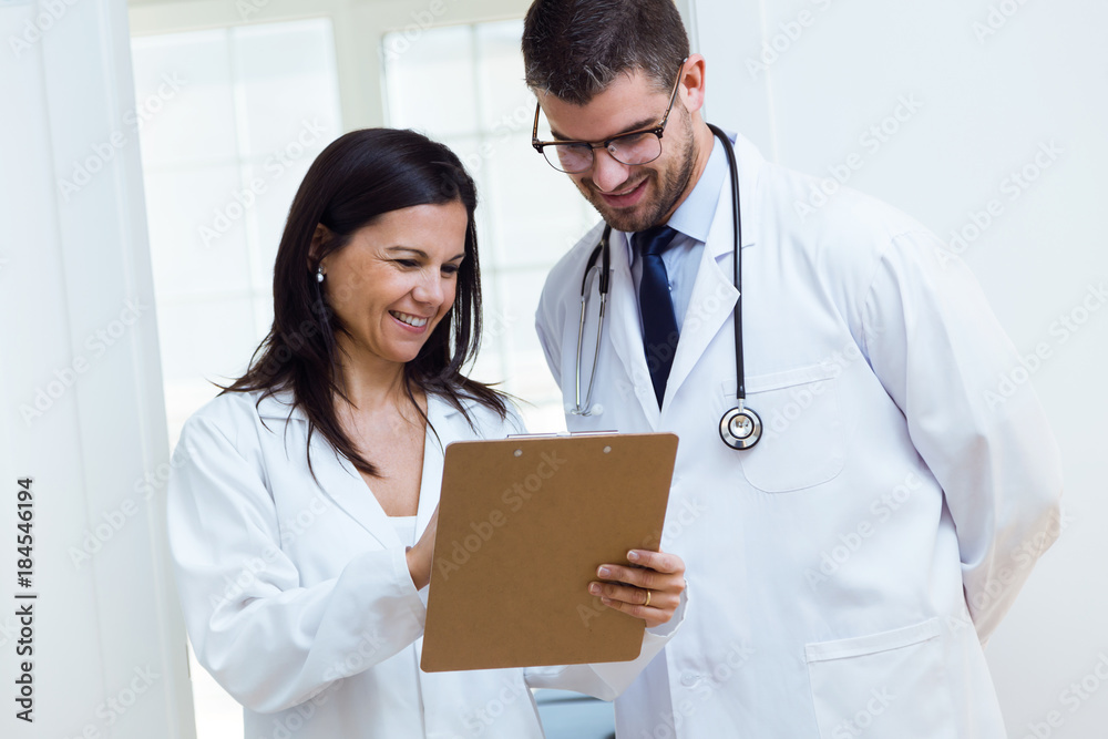 Confident male doctor and his nurse working in the office. Confident male doctor and his nurse working in the office.