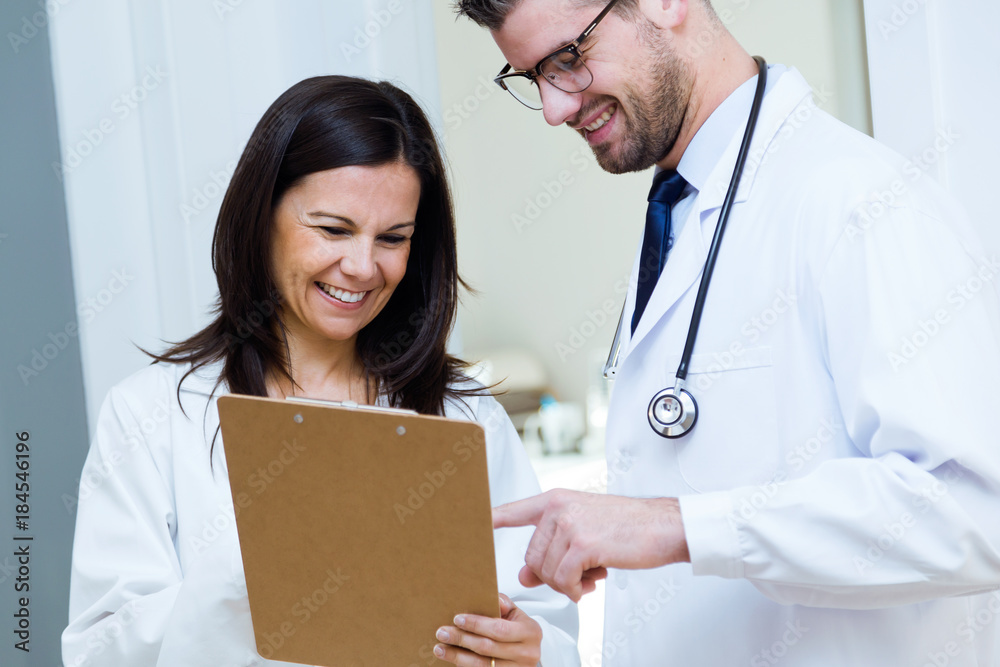 Confident male doctor and his nurse working in the office. Confident male doctor and his nurse working in the office.