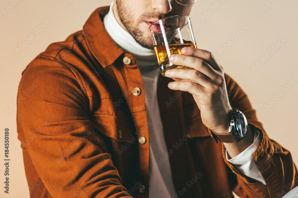 Φωτογραφία partial view of man in stylish clothing with glass of whiskey in hand isolated o