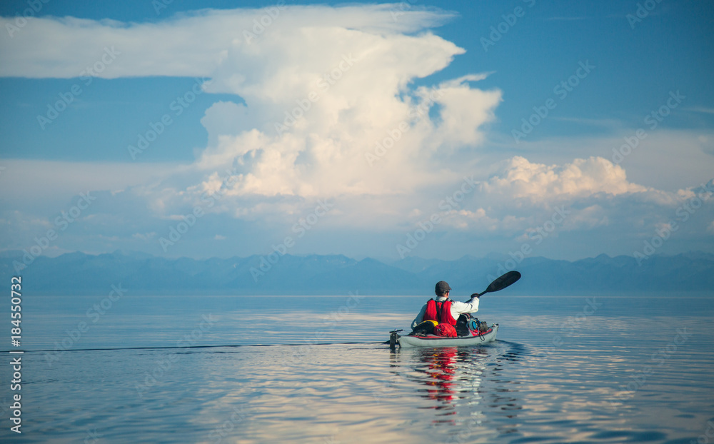 Mеn kayaking on Lake Baikal. Landscape. Siberia.