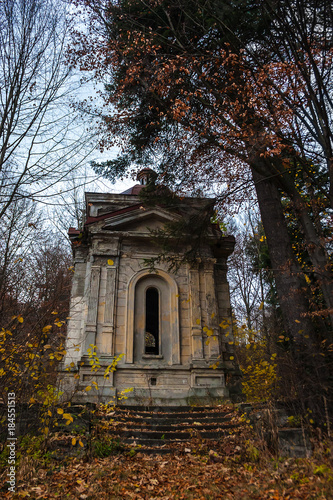 A weathered spooky crypt in the forest late autumn