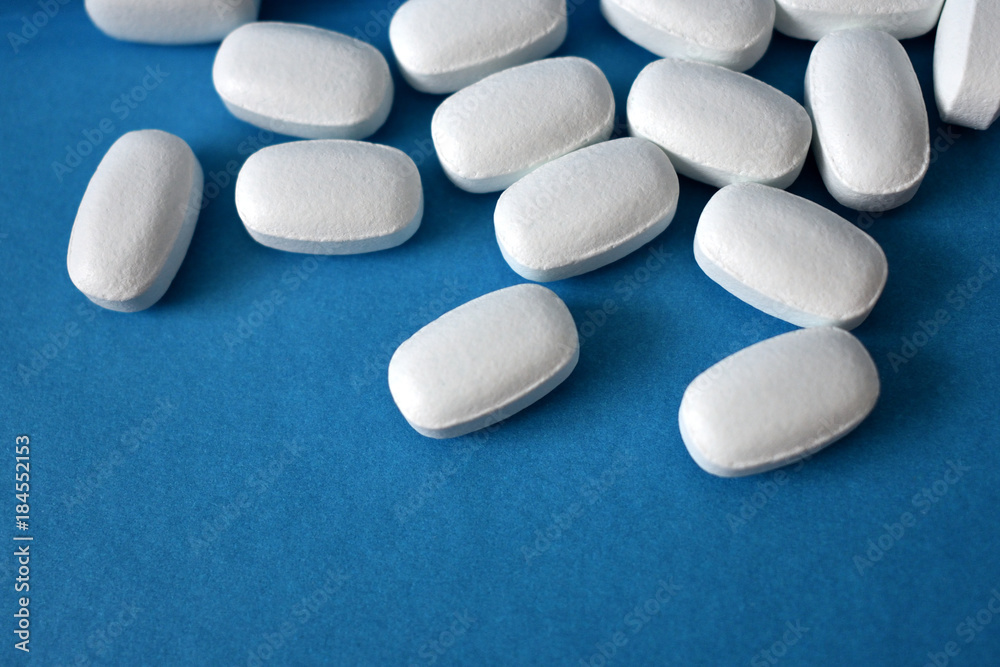 white pills on a blue background