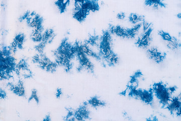 Pattern of blue tie batik dye on cotton cloth, Dyed indigo fabric background and textured, Painted blue watercolor on white cotton cloth